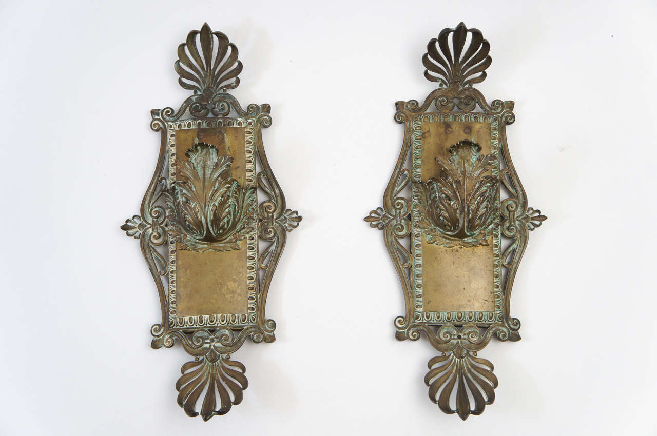 Beaux-Arts period solid bronze wall sconces of exceptional design having pronounced anthemions either end of gently bowed back-plates with egg-and-dart borders.