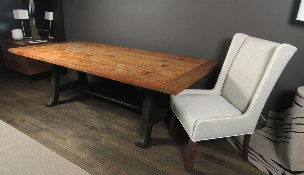 Vintage dining table made with a reclaimed solid oak, natural finish and a vintage steel u-frame base.