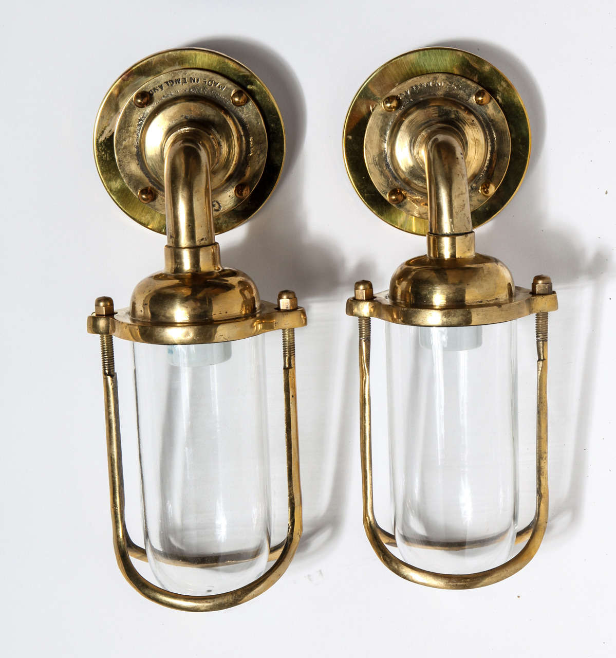 Glass and brass antique sconces featuring cast manufacturers mark 
