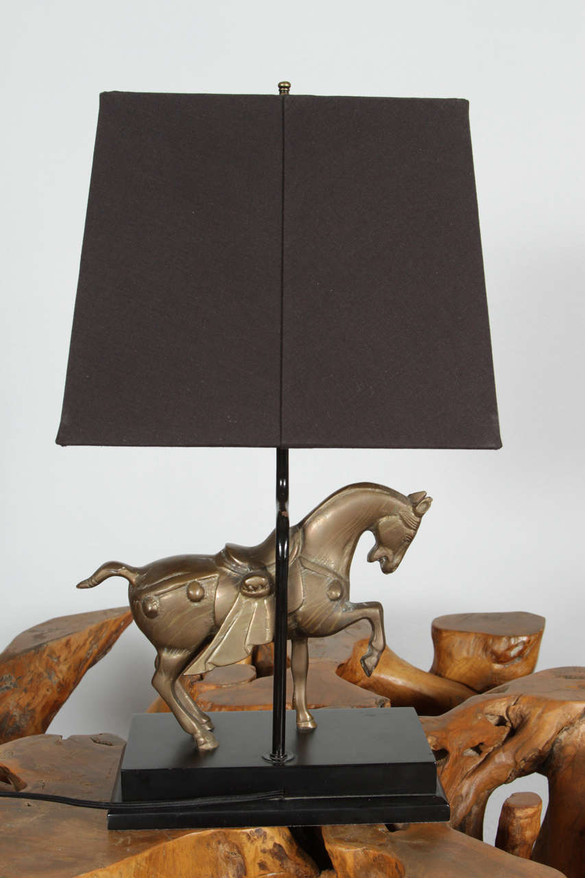 Pair of 1910-1950 immaculate brass Trojan horse table lamps on black lacquered wood base.