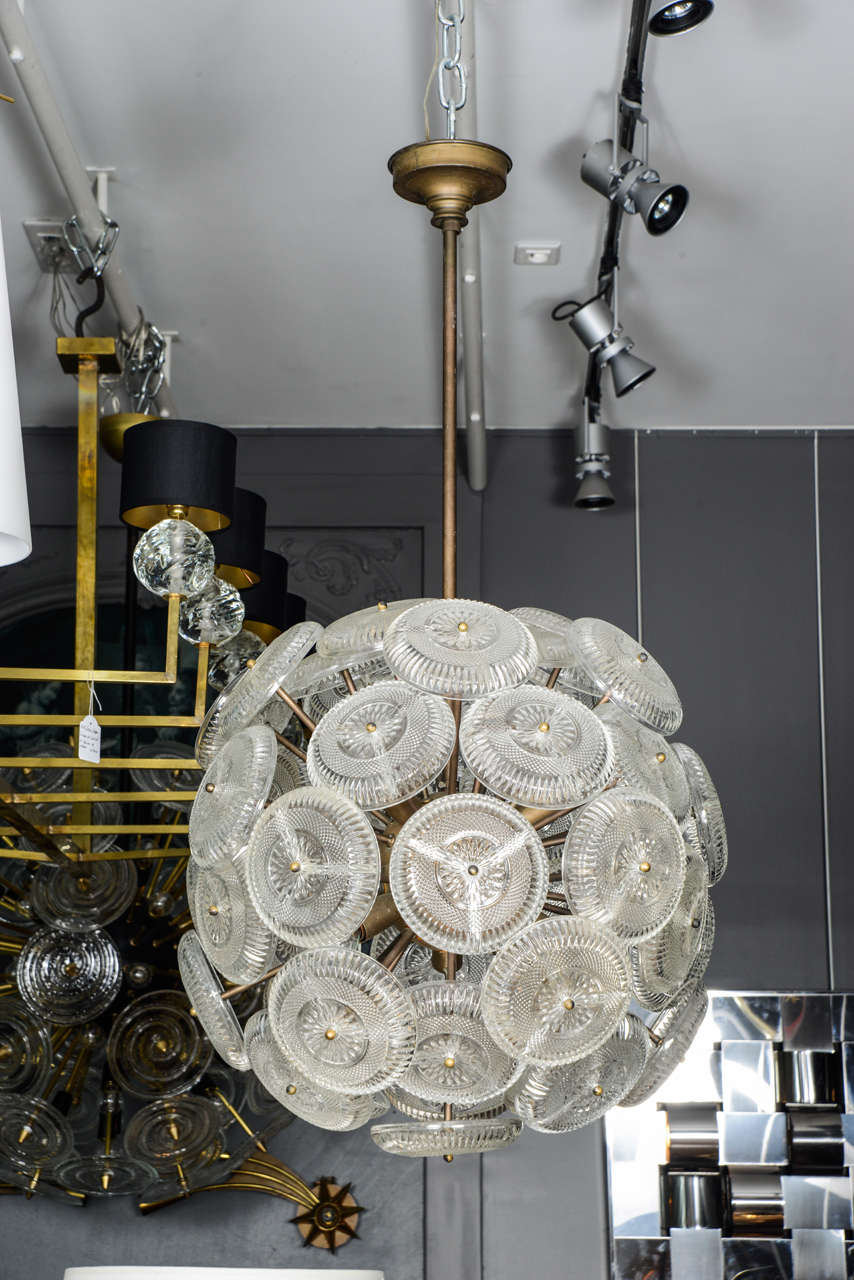 Rare little Sputnik style chandelier made of a brass round structure and beautifully engraved glass plates.