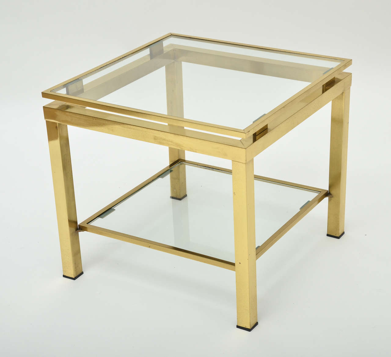 A 1970s French brass and glass side table with two tiers.