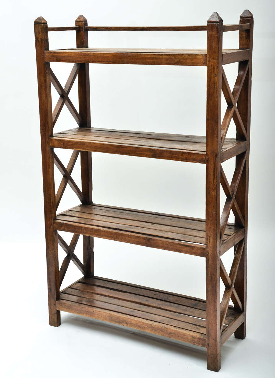 A 19th century Anglo-Indian teak open bookcase with four slatted shelves.