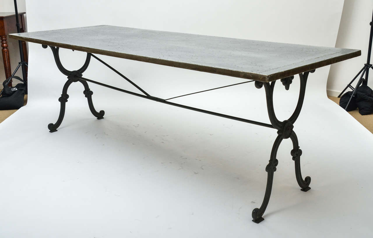 A 19th century Cast Iron Base Writing/Dining Table with iron stretcher base from a conservatory in East Sussex, England, with original dark green paint, later zinc top (6'11' L ).