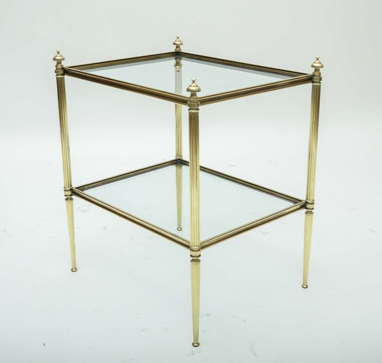 A 1940s Maison Jansen Bagues-style brass and glass side table with reeded legs and foot, highly decorative turned brass finials.