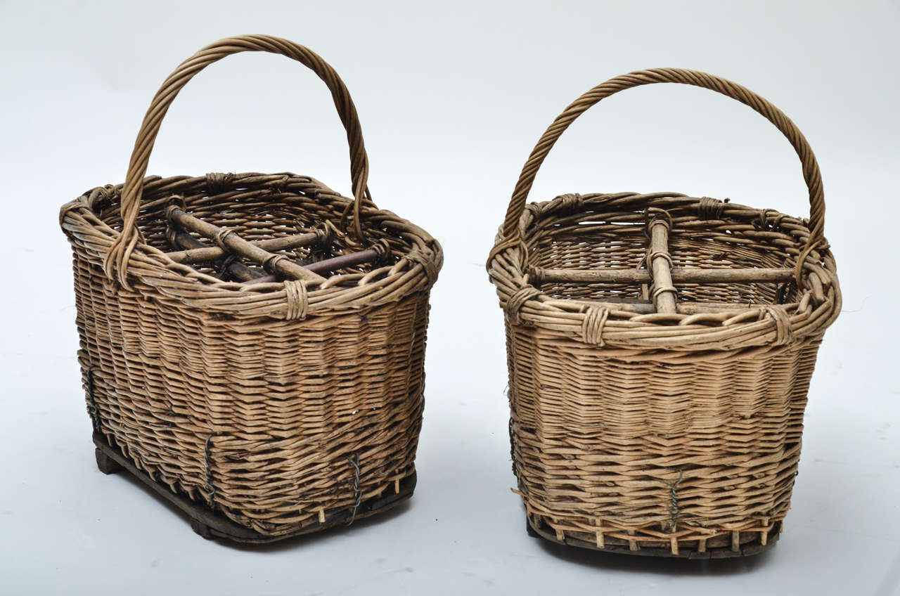 A pair of 1920s French wicker wine baskets.