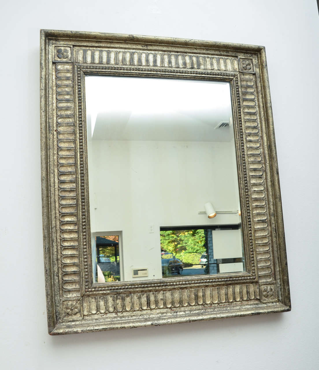 A turn-of-the-century German silver giltwood mirror with beaded frame, wonderful decorative detailing and patina.