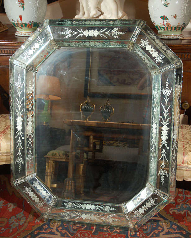 Large, etched, Venetian mirror with floral details.