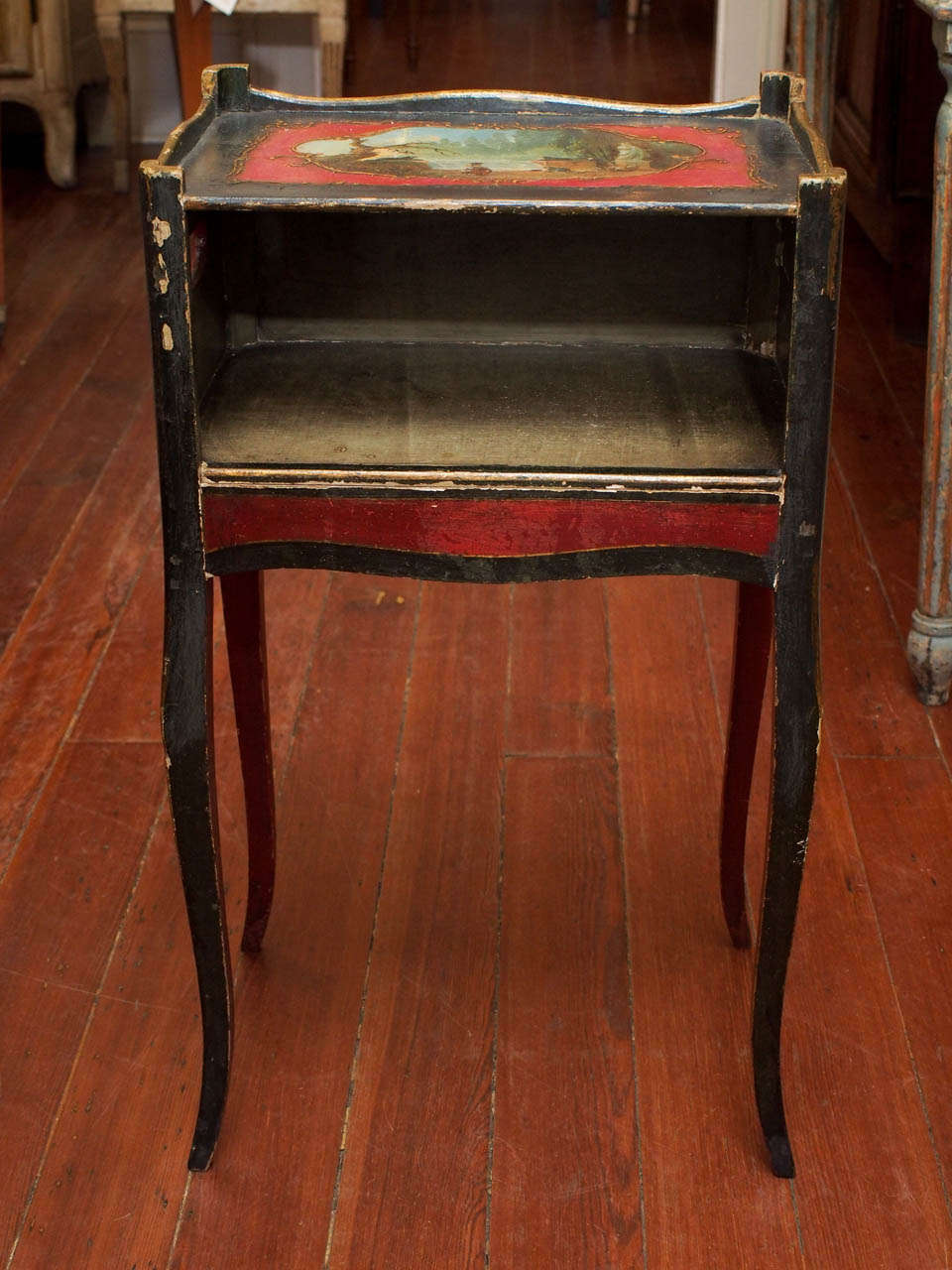 A Louis XV style  French nightstand with an open shelf over slender cabriole legs, the top painted with landscape in a medallion.