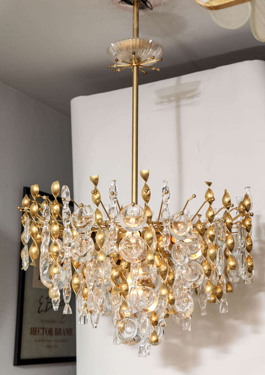 A fabulous jewel-like Gaetano Sciolari pendant chandelier with crystal lens pendants and glass and gold plated brass twists.