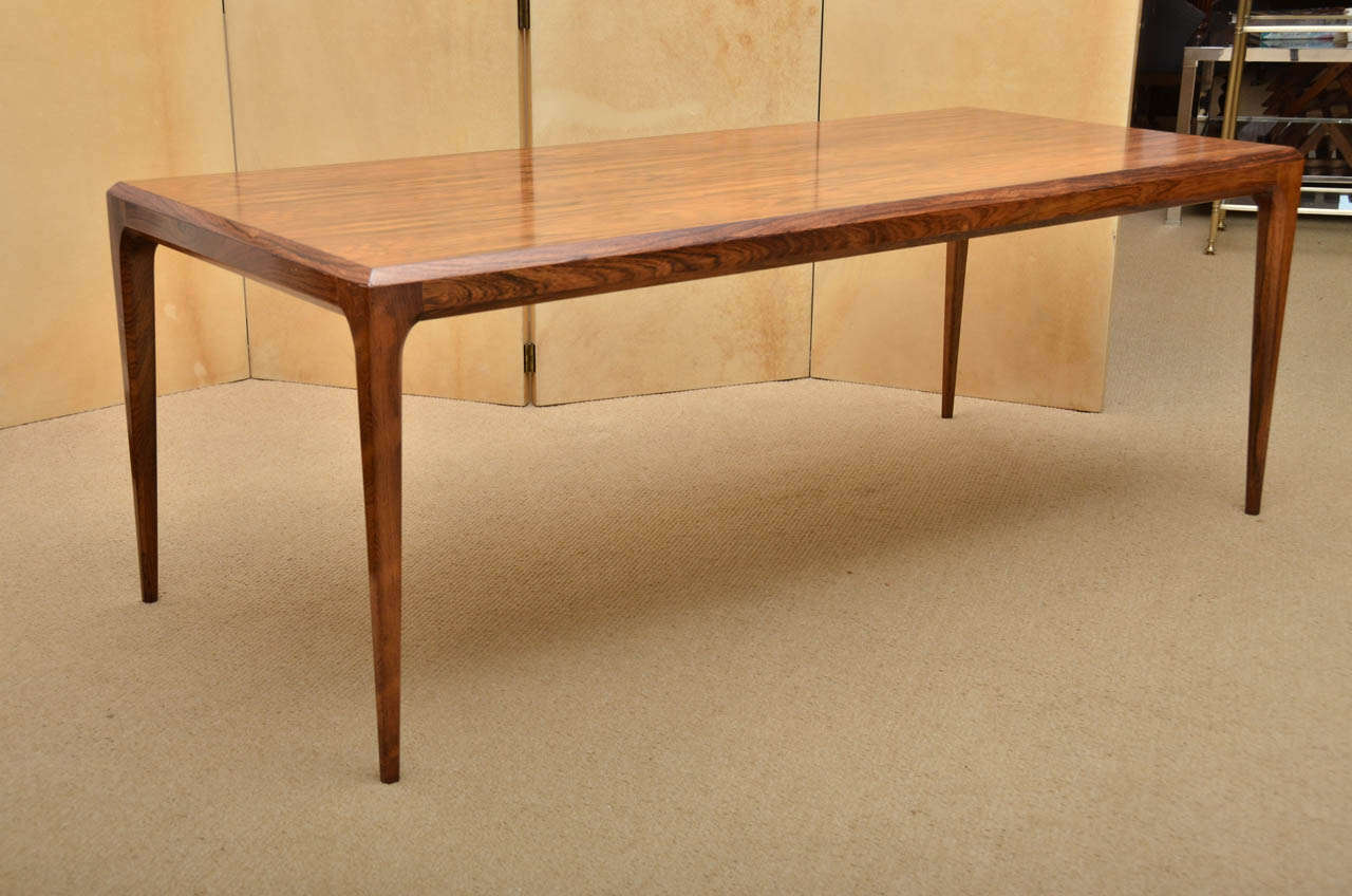 A 1970's rosewood coffee table made in Denmark (Sikeborg) with original label, chaufered corners and tapered legs.