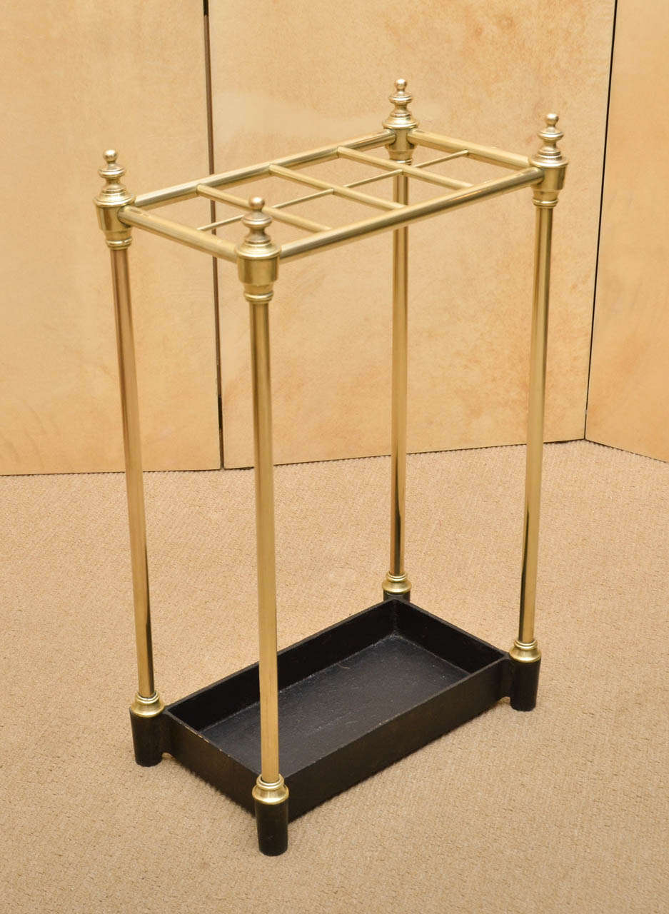 19th century, eight-slotted brass umbrella stand with iron base.