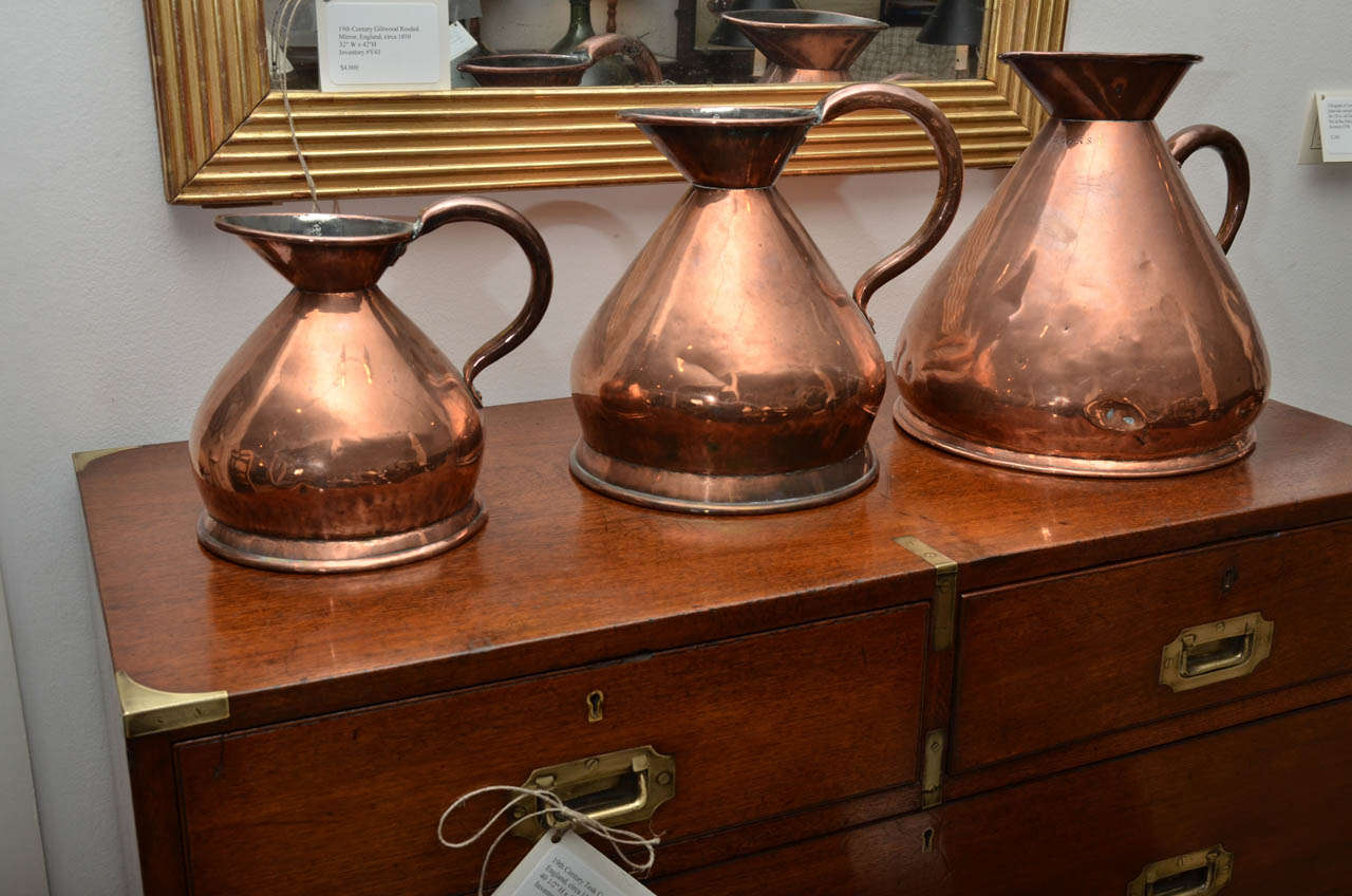 A matched set of three 19th century copper pitchers (stamped Victorian), three sizes, two gallon, one gallon, 1/2 gallon. One gallon and 1/2 gallon are identical, two gallon difference in handle and base.