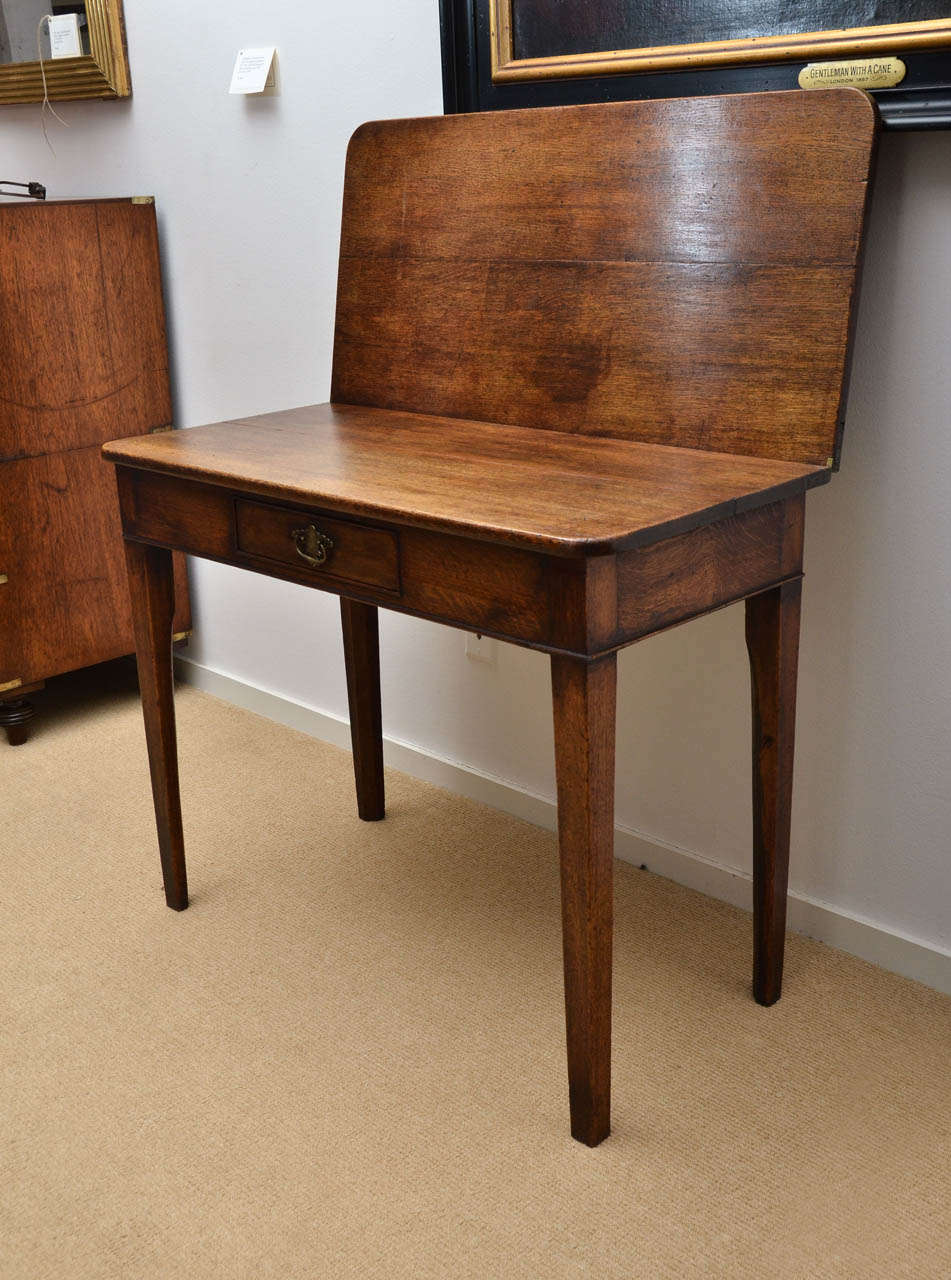 A 19th century gateleg folding tea table with fitted drawer and squared legs.