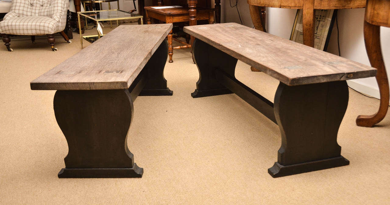 A pair of turn-of-the-Century walnut benches made in the carpenter's workshop on the Edwardian country estate of Benacre, in Norfolk.