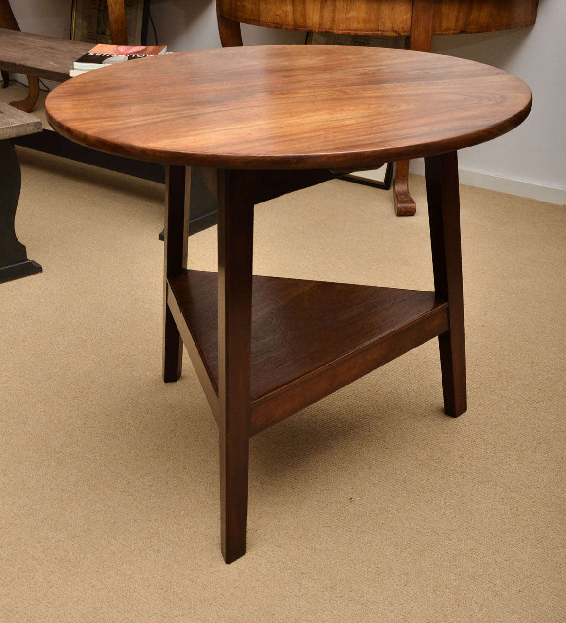 An early 19th century cricket side table, two-tiered, three-legged mahogany table.