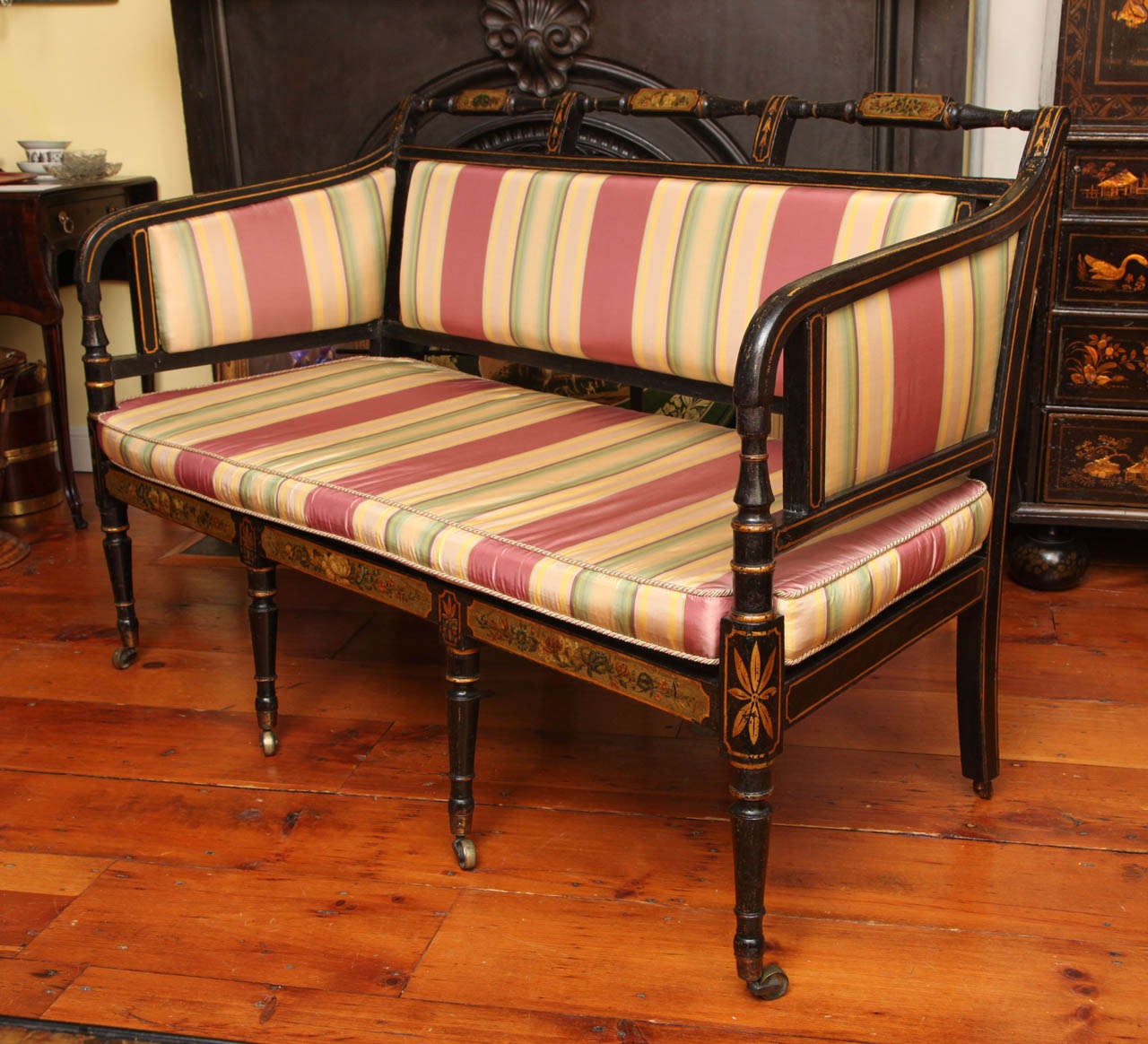 Very Fine Sheraton Period Japanned Settee, having a finely turned crestrail having three floral-painted tablets with two downswept arms, the cushioned seat with above a floral-painted rail and four front turned tapered legs ending in brass cups and