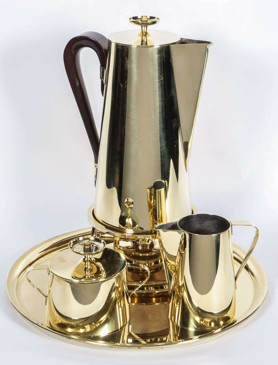Exceptional coffee service in polished brass by Tommi Parzinger comprised of a round tray, coffee pot with stand and warmer, creamer and sugar bowl.