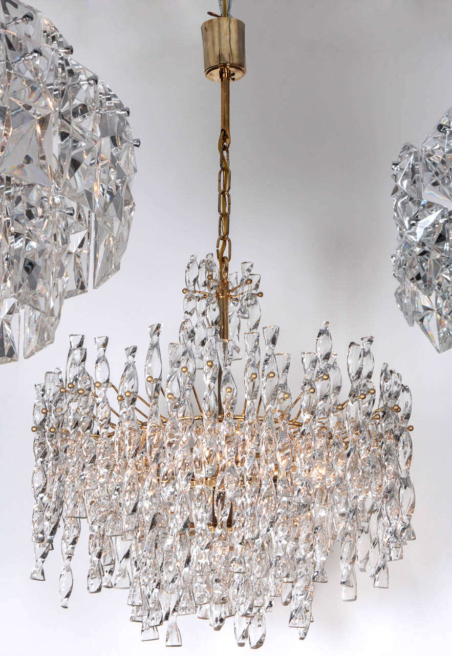 Fantastic multi tiered chandelier composed of spiral glass rods on a 22kt gilt washed bronze frame.  Currently, 3  matching sconces are available. Glass body measures 17 inches long, and has 7 sockets.