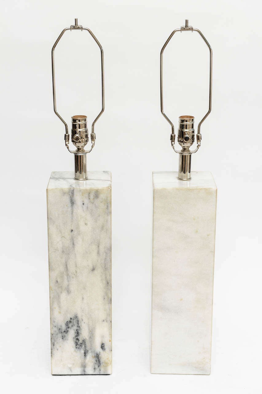 This pair very handsome and  modern vintage carrara marble lamps made a great statement. They have all been rewired
and know that that due to the differences in slabs of marble they  echo each other in a pair but not in their variances of the