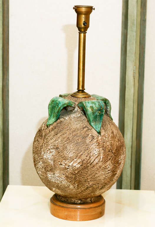 Here is a great ceramic sphere lamp with a textured matte surface.<br />
The four leaf motif is glazed in a glossy Majolica like finish.<br />
The lamp is mounted on a round  cerused oak base.