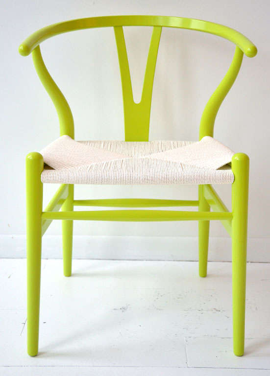 Chartreuse wishbone chair with white woven seat.
