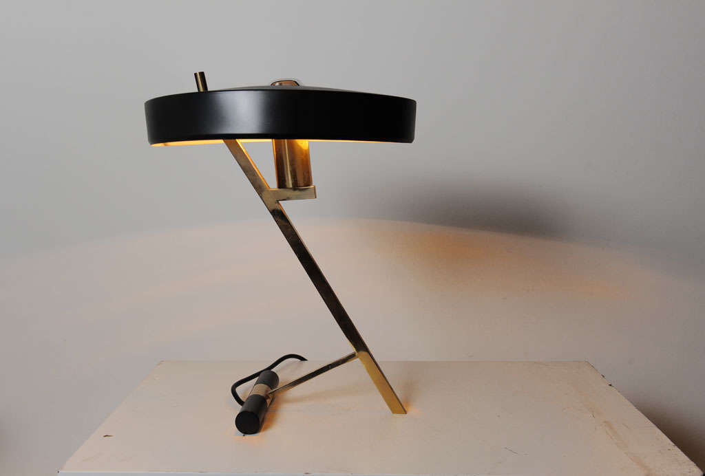 Rare Z-shaped desk lamp designed by former head-designer at Philips Netherlands Louis Kalff. Beautifully designed brass Z-frame and still has the original brass manufacturer tag on the shade. Two identical available.