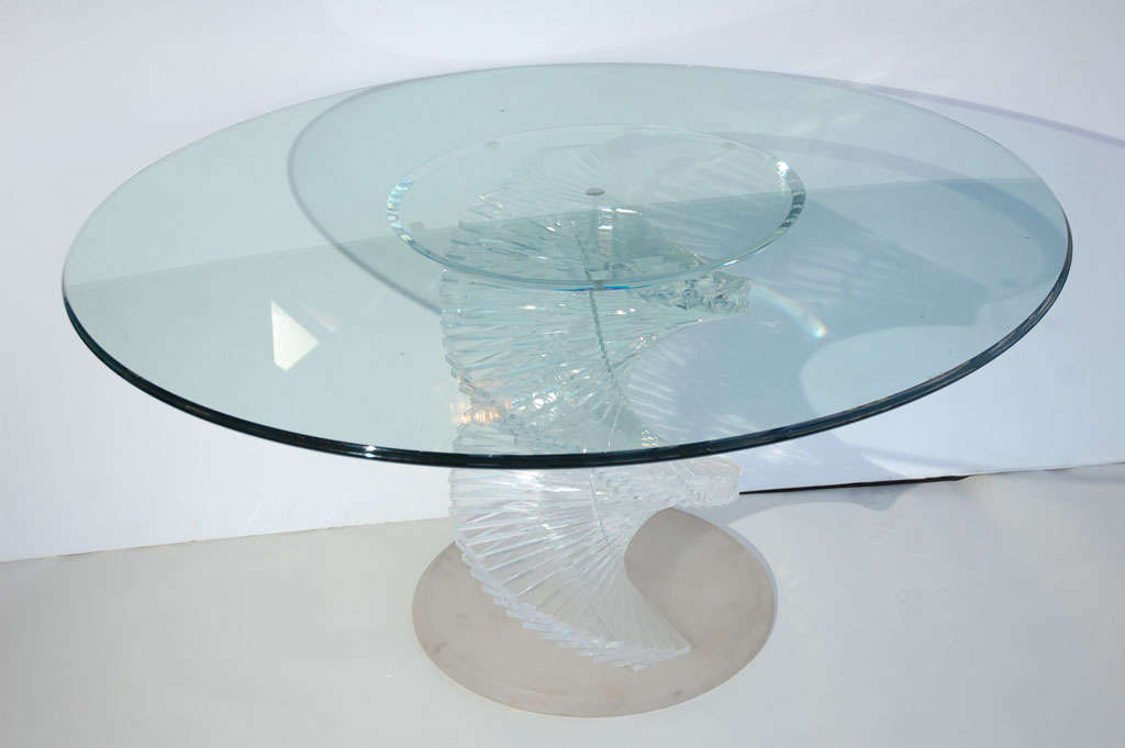 A sculptural spiraling Lucite table with a glass top. Base is frosted Lucite. Lucite spiral is clear.