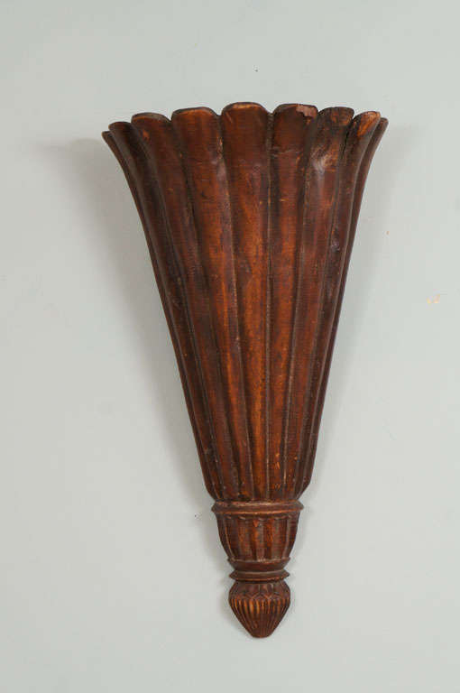 Pair of neoclassical style carved wood reeded trumpet-form wall lights.