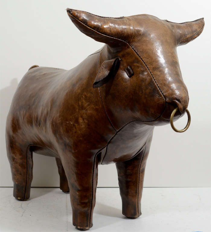 A vintage sculptural leather footstool by Omersa for Abercrombie and Fitch in the form of a bull with a brass ring through its nose. 

Reduced from:  $3,750