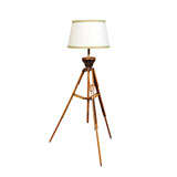 Oak and metal surveyor's tripod mounted as a floor lamp