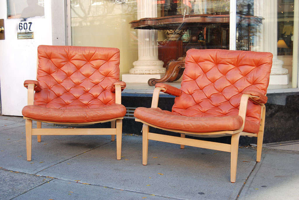 Pair of chairs by Swedish designer Bruno Mathsson known as the 'Ingrid' chair,  in beechwood with pale red tufted leather seats, for Dux,  mid-century modern