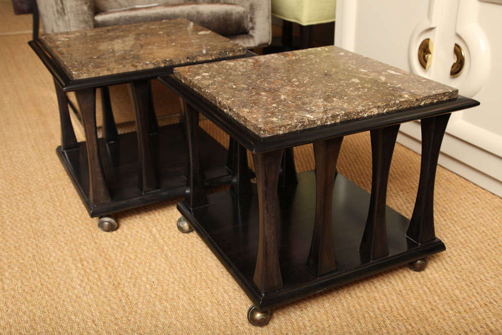 Pair of ebonized occassional tables with brown marble and round brass casters, c.1960