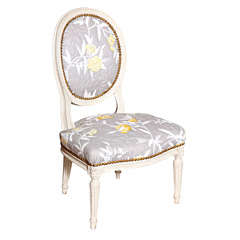 A Carved and Painted Louis XVI Petite Oval Chair