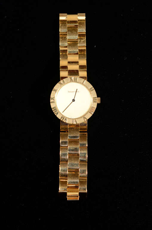 This luxurious watch is 18k gold  with relief Roman numerals and a quartz movement.This watch has the original box with an extra link. Would be gorgeous on a woman as well.The weight of the watch is 55.22 DWT and the round case is approximately 31