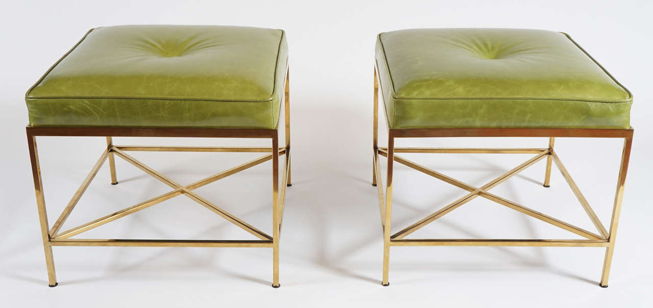 Chic pair of vintage brass frame stools having x-form stretchers and conforming side stretchers with newer lime green doe-skin supple leather upholstery.  Probably originally bespoke as they're similar in style to stools designed by Paul McCobb but