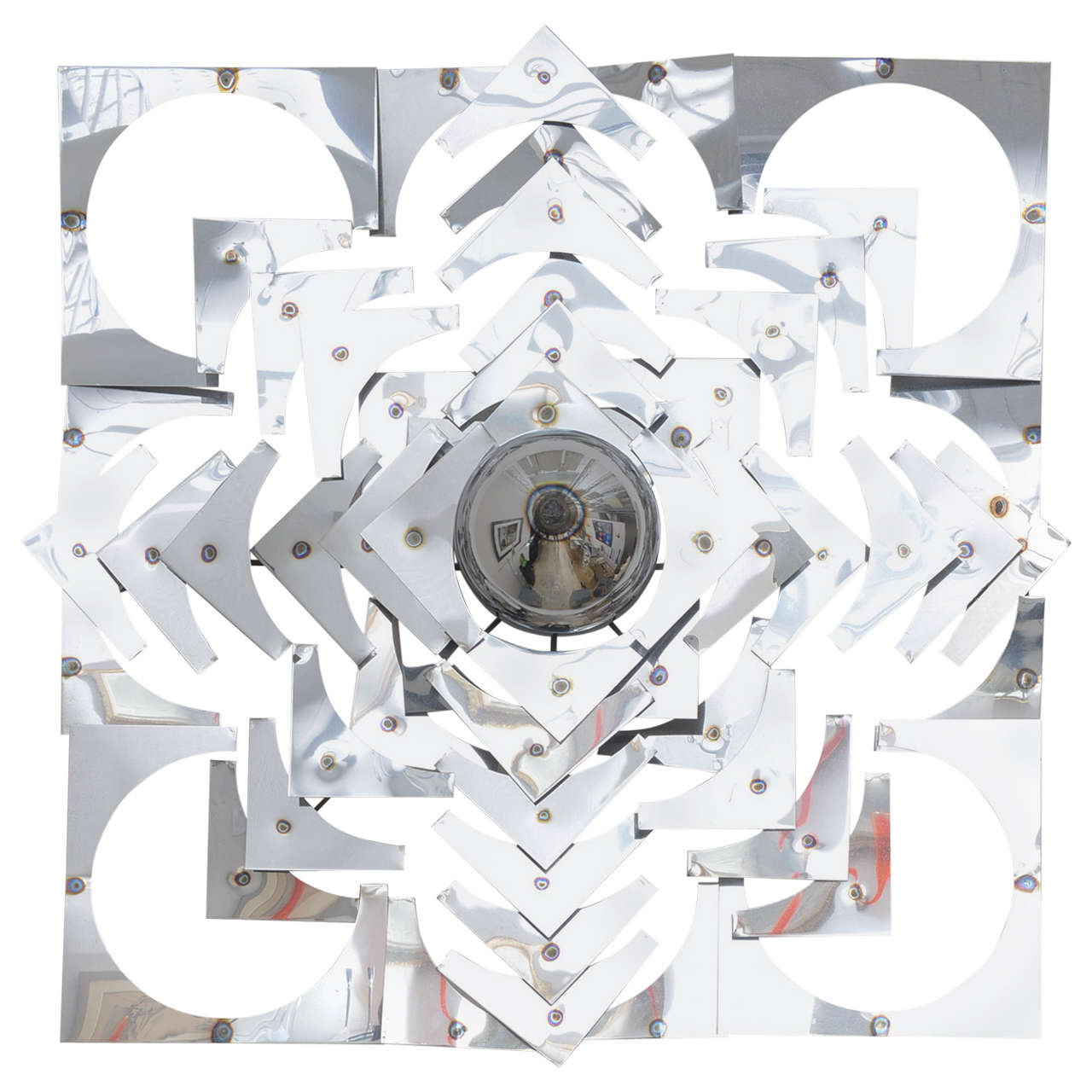 This large-scale wall sculpture was created in the 1970s and is very much a take on the kaleidoscope with its geometric shapes and forms in a stylized pattern.  The use of polished chrome gives the piece great deal of movement as the light plays