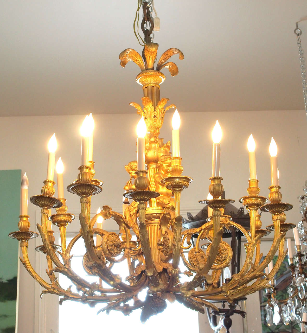Large, bronze chandelier with cherub decoration and 18 lights