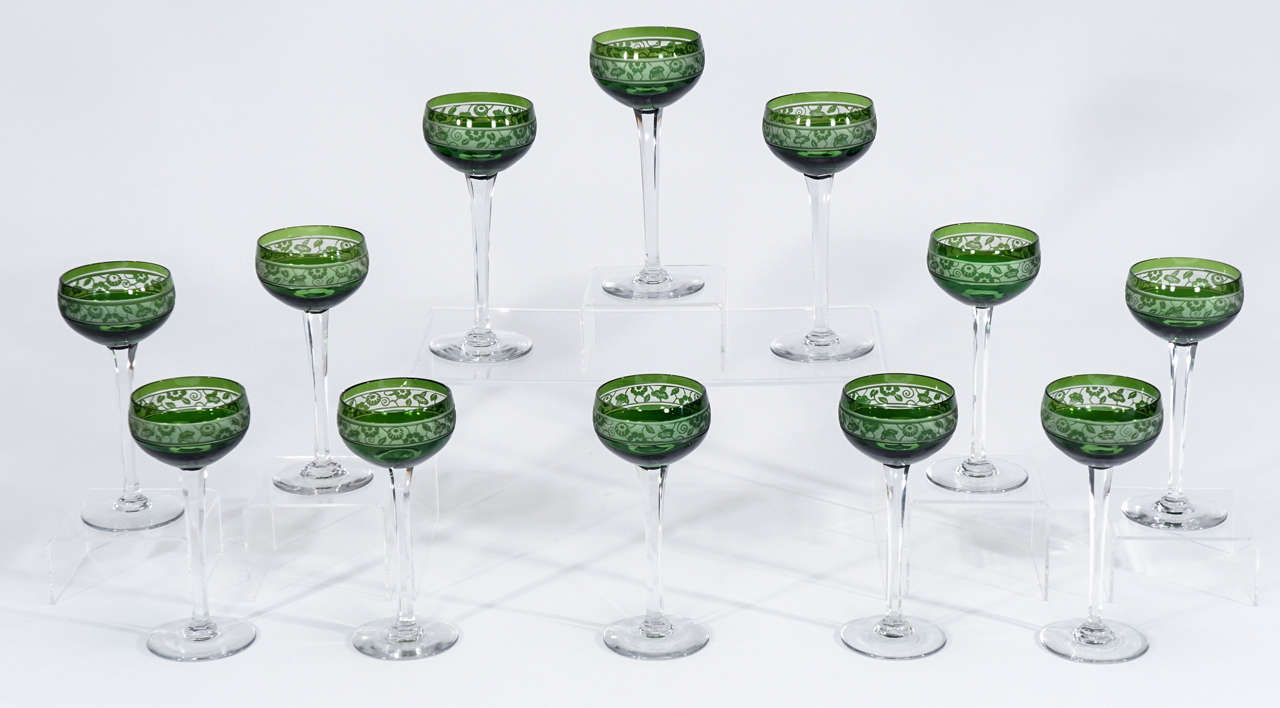 A lovely set of 12 signed crystal, Nancy, French handblown crystal hock wine goblets. The tall and elegant forest green goblets contrast beautifully with the band of Art Deco cameo cut decoration, handblown crystal with green overlay cut to clear-