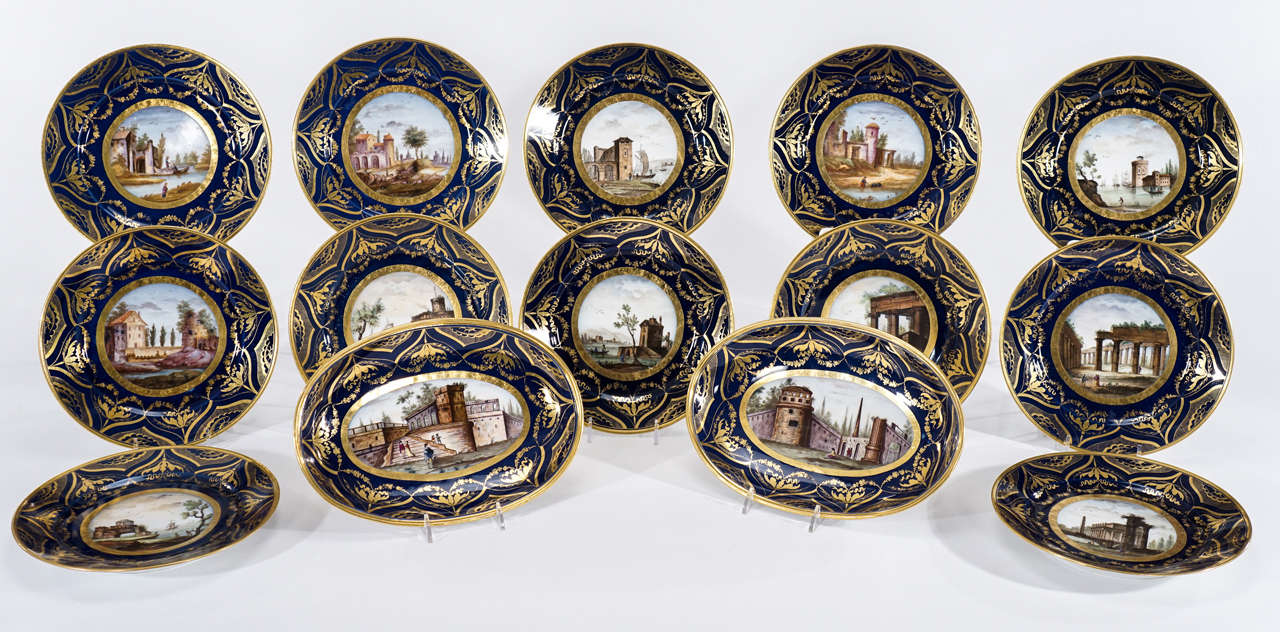 This is a museum quality early 19th century 14-piece dessert service made by Darte Frères Paris, circa 1810. Each plate is decorated with a hand-painted center depicting named scenes in Italy, ie "Vue Romain", "Vue de Napoli,"