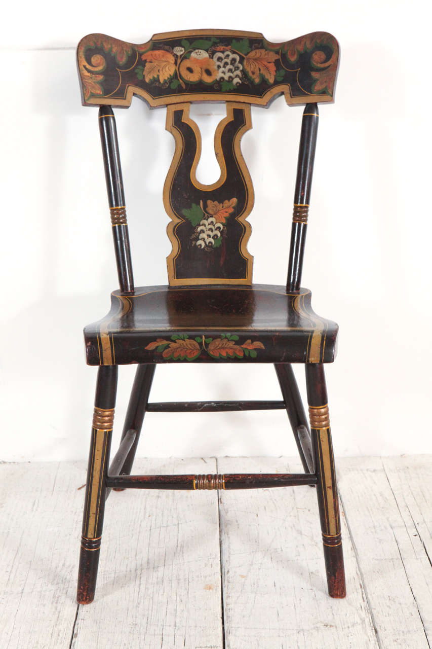 Black and gold hand painted decorative dining chairs.