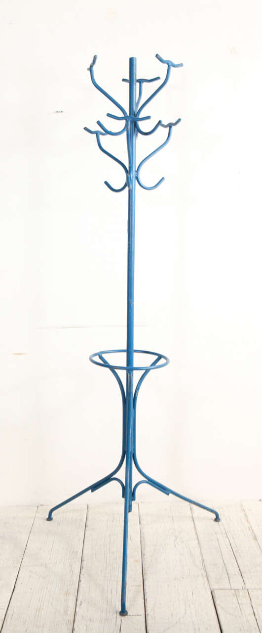 Bright blue painted metal coat rack with six hooks and umbrella storage.