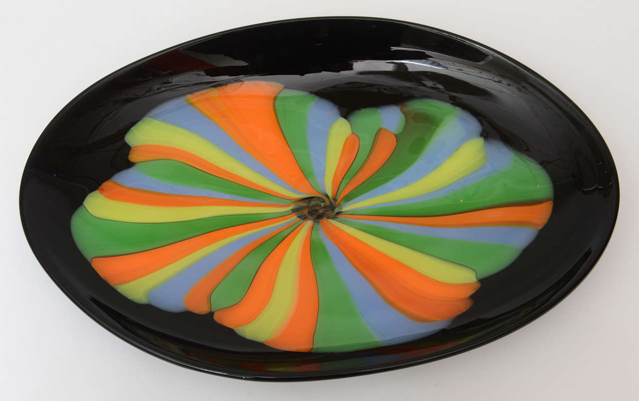 This beautiful and dramatic play of colors of orange, periwinkle, green, yellow against the black glass background make this Italian Murano vintage Seguso signed centerpiece, serving bowl and or platter pop! It is an abstract flower blossom or