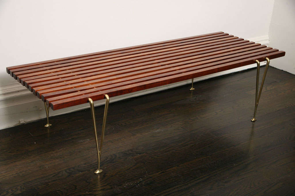 A 1950s modernist wood and brass low table by Hugh Acton.