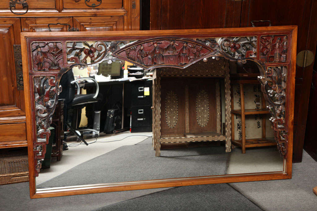 This large size horizontal elmwood mirror is made of a 19th century lacquered carving originally part of wedding bed. This delicate carving now adorns a clear mirror that beautifully highlights its decorative aspect. The carving, showing a nice