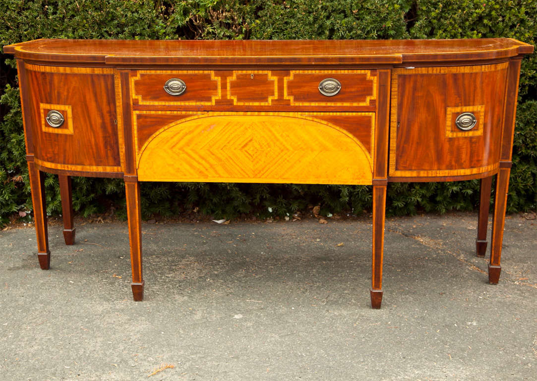 English Sheraton sideboard with satinwood veneer in geometric designs around the two large drawers and doors-cross banding on top.