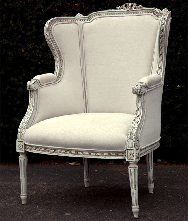 Highly carved Swedish bergere chair with milk paint finished.  Recovered.