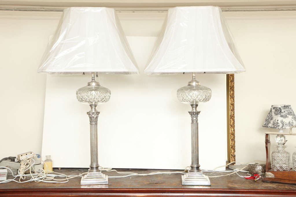 Pair of silver plated, column-form, electrified oil lamps with cut crystal oil fonts, England, Ca. 1900. Total height to top of finial is @34