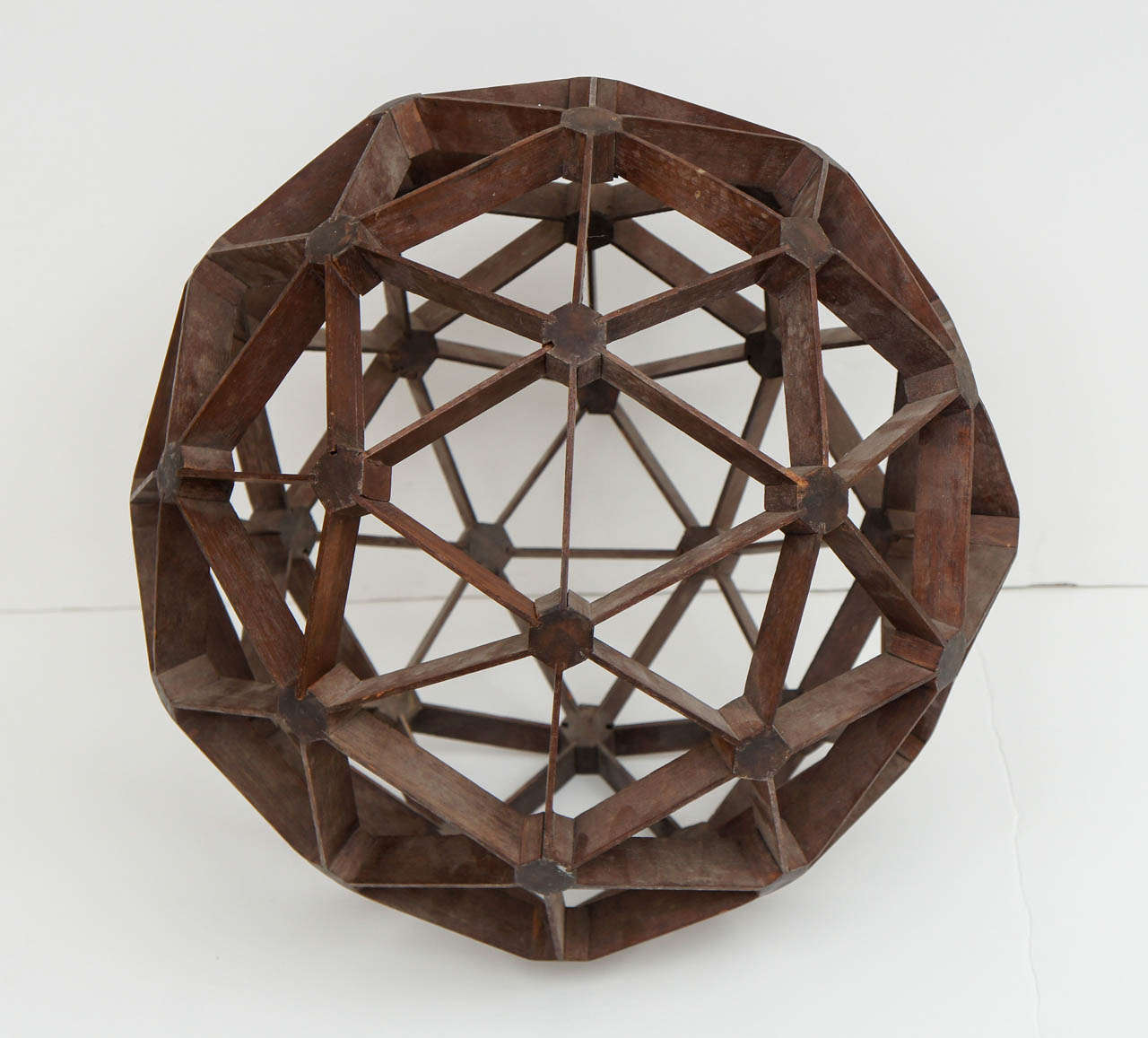 Early 20th Century Hand Created Sculpture.
A Perfect Geodesic Sphere made from Pieces of Mahogany and Joined without Nails.