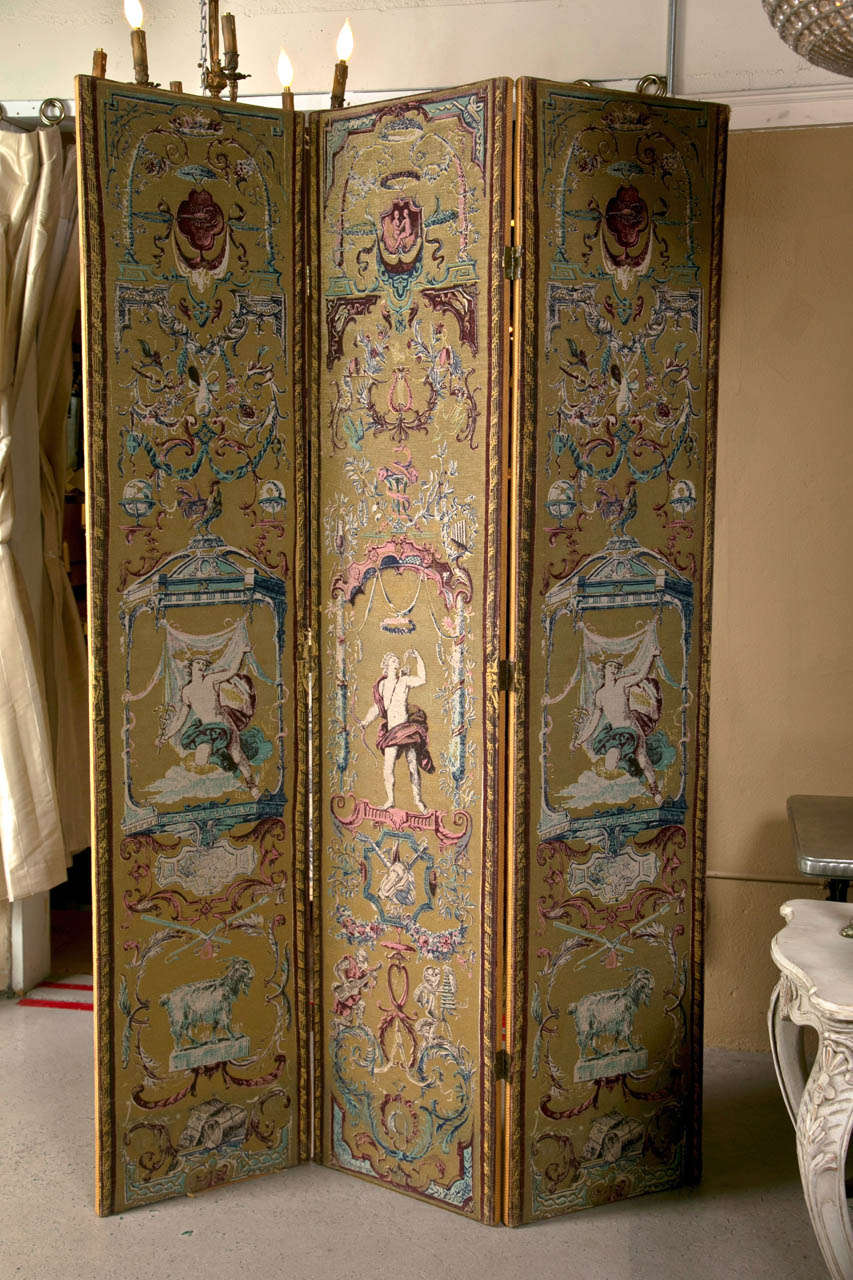 Pair of three-panel folding screens in the style of Renaissance Revival (default showing a mirror image, the actual screens each has slightly different patterns), circa 1950s, the beige and maroon needlepoint canvas depicting roman motifs, hinged